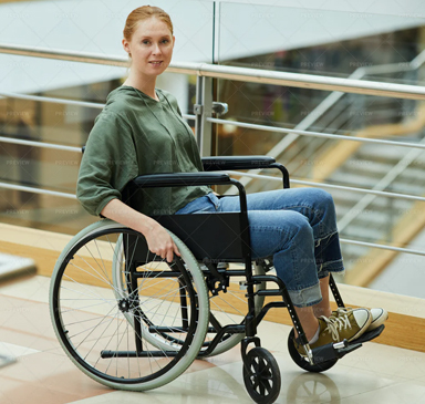 Young girl sitting in a wheelchair looking straight ahead.