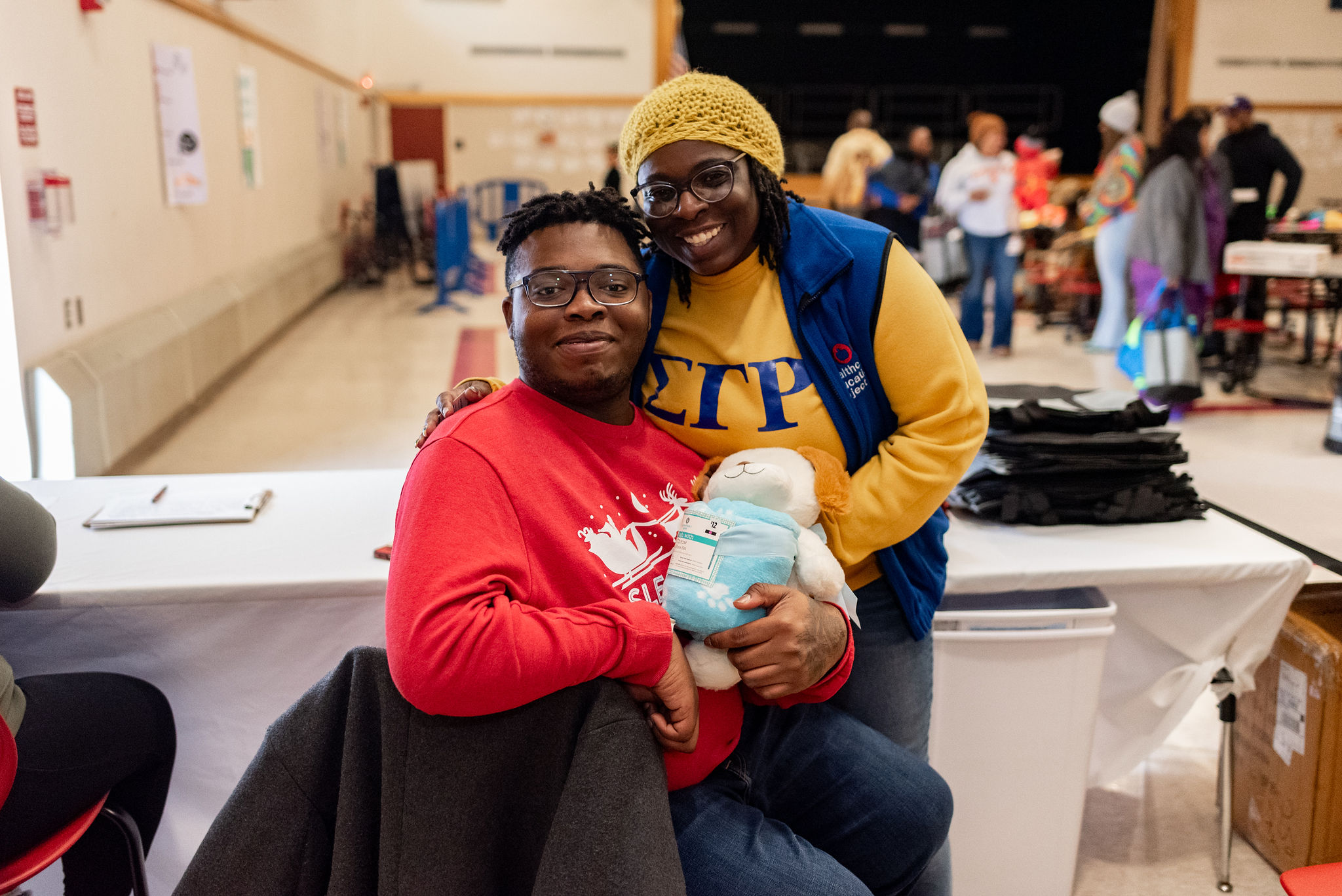 Latoya Jones-Joe and Nyshon Joe. He sits with a stuffed animal in his arms while she stands and leans close to him and smiles.